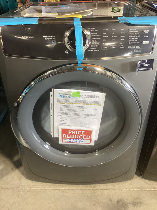 A dryer with a sign on it indicating there is a discount on the original price.