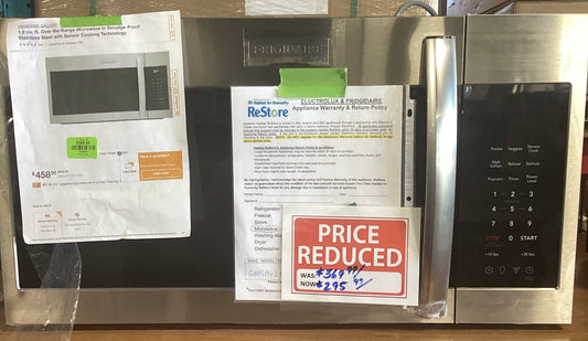 A microwave with various papers on it indicated discounts and product information