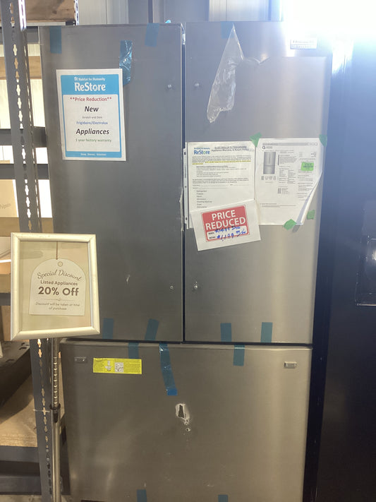 A refrigerator with a sign indicating that the item is being sold at a discounted price.