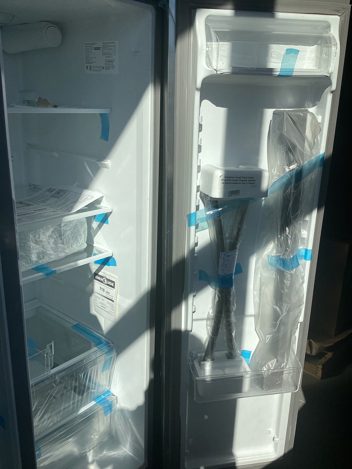 A refrigerator with a plastic bag covering the door, preventing air from entering.