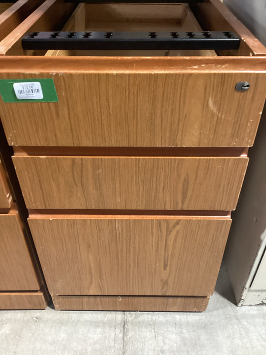 Wooden cabinet with green sticker, perfect for adding a pop of color to any room. Sturdy and stylish storage solution.