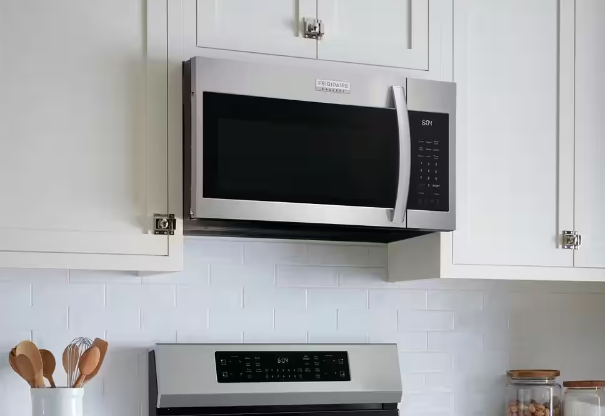 A stainless steel microwave oven in a white kitchen, providing convenient cooking options.