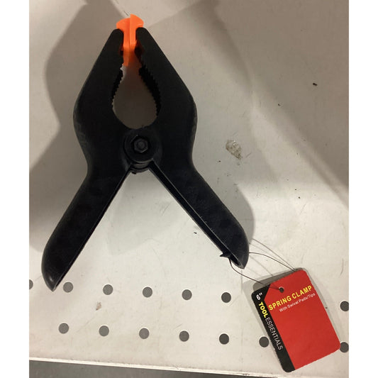 A black and orange clamp with a tag attached.