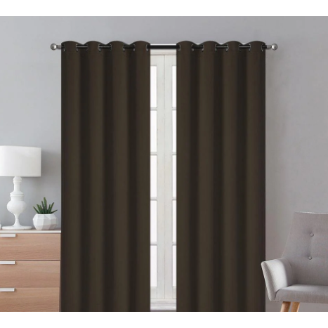 Coffee blackout curtains hanging in a room, blocking out sunlight and providing privacy.