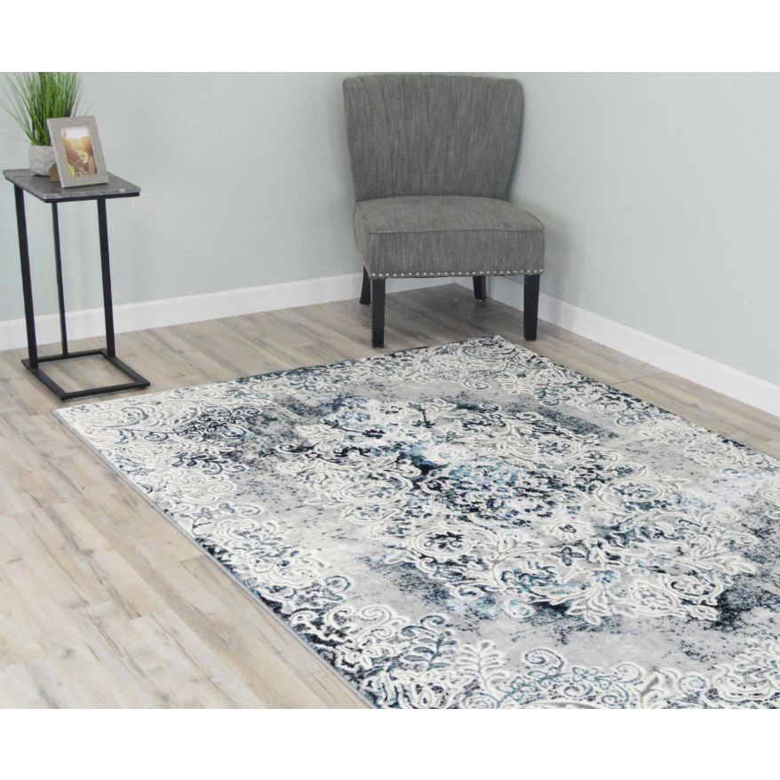A blue and white rug with a beautiful design on the floor.