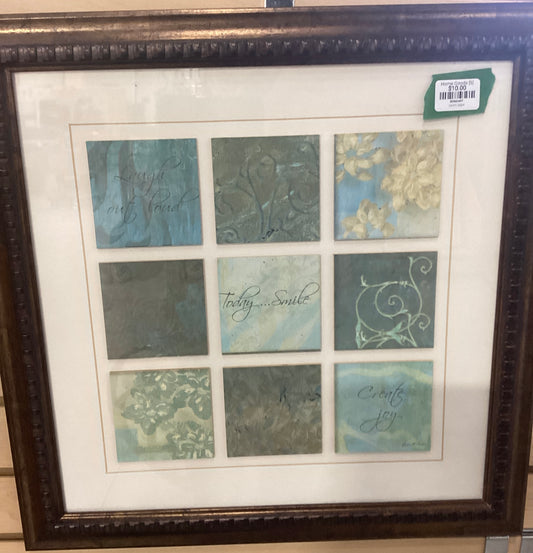 A framed picture showcasing a variety of colored tiles arranged on a wall.