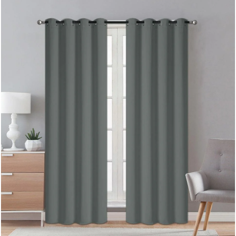 Silver blackout curtains hanging in a room, blocking out sunlight and providing privacy.